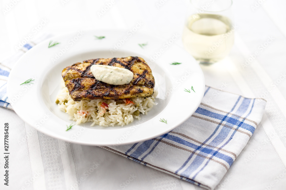 Mahi mahi grilled fish with rice and wine. This lean tropical white fish is also known as common dolphinfish or dorado. Considered an healthy food rich in protein, it is perfect for bbq grilling. Mahi mahi grilled fish with rice and wine. This lean tropical white fish is also known as common dolphinfish or dorado. Considered an healthy food rich in protein, it is perfect for bbq grilling.