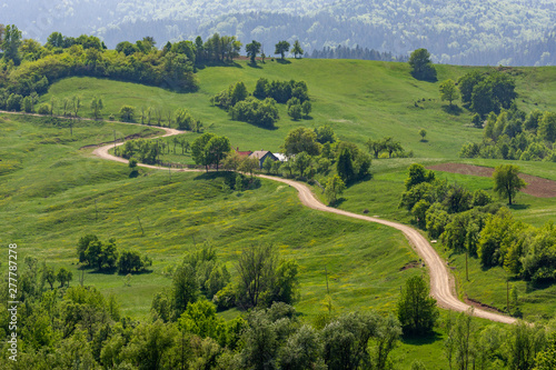 Beautiful sinuous road in Bucovina rural area, Romania