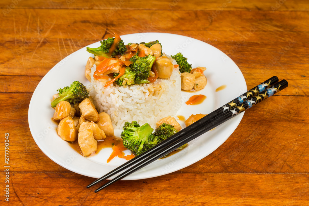Chicken and Broccoli Stir Fry on Bed of Sticky Rice with Chopsticks Chicken and Broccoli Stir Fry on Bed of Sticky Rice with Chopsticks