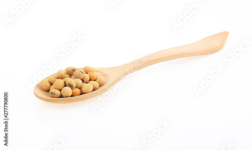 Soy beans in spoon on white background