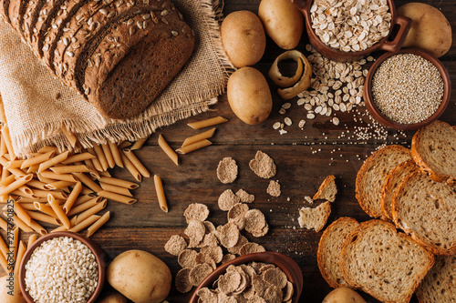 Wholegrain food and freshly baked rye bread on table photo