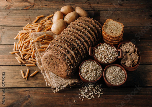 Wholegrain food pasta and freshly baked rye bread on table photo