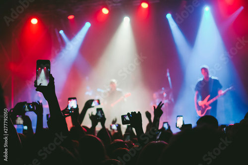 Wallpaper Mural Raised up hands with cellphones recording videos from music show Torontodigital.ca