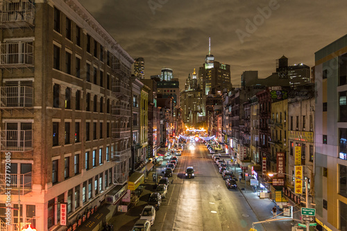 Manhattan bridge view over Chinatown at night, lower Manhattan in the background. New York City, United States of America.