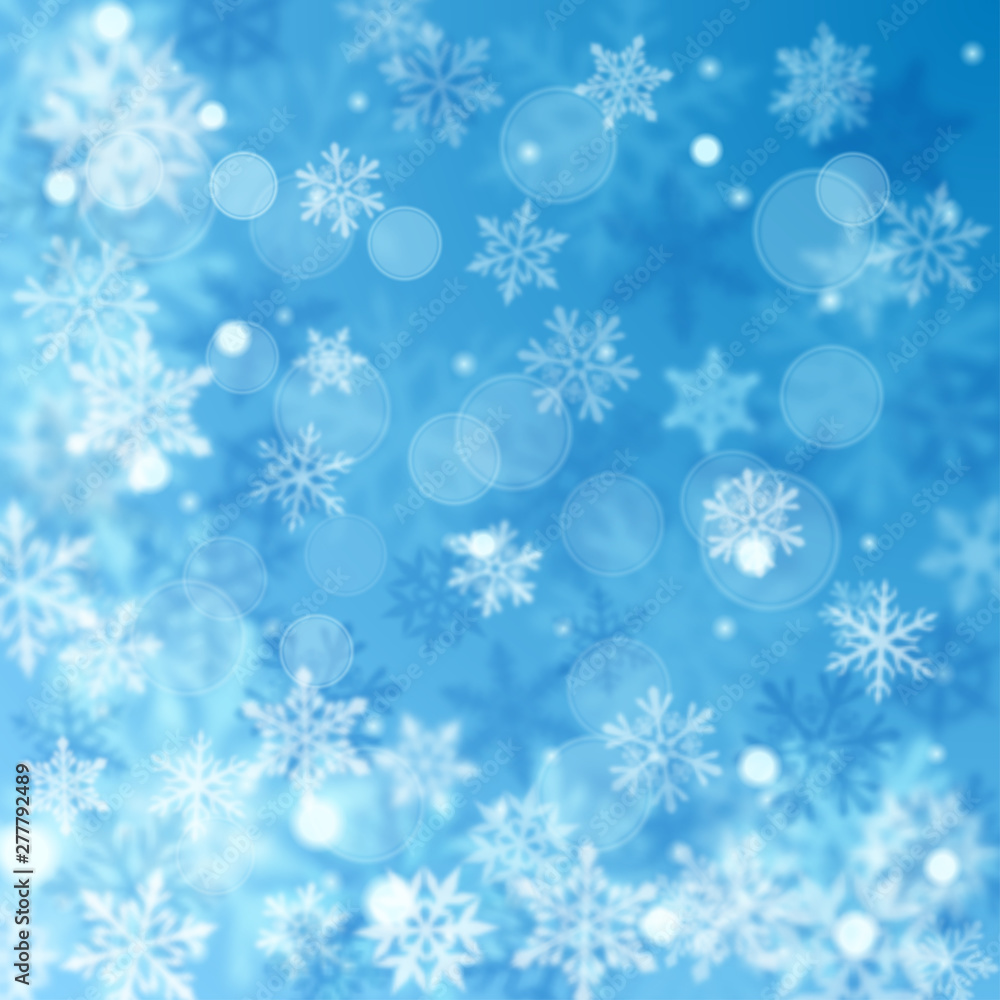 Christmas blurred background of complex defocused big and small falling snowflakes in light blue colors with bokeh effect