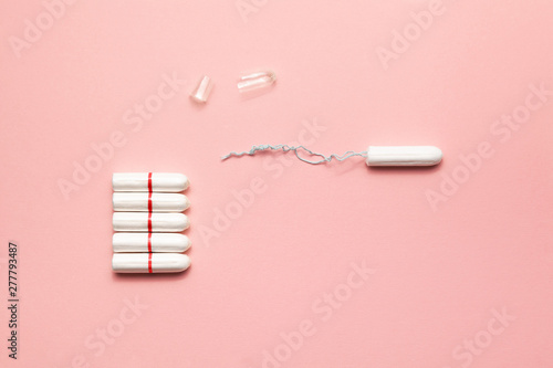 Unpacked tampons on a soft pink background. Modern female intimate gynecological hygiene. Eco zero waste concept. Copy spase place for text. Flat lay