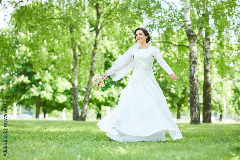 bride in wedding dress dancing in park bride in wedding dress dancing in park
