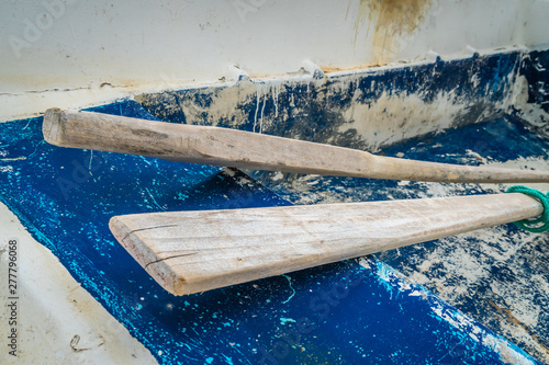 Wooden oars in old rowing boat