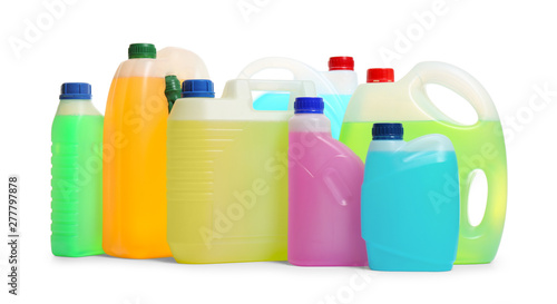 Plastic canisters with different liquids for car on white background