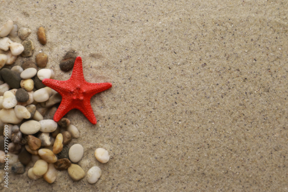 Seashells and pebbles on sand background Seashells and pebbles on sand background