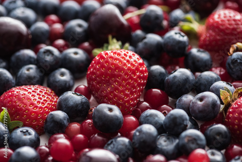 selective focus of red  fresh and ripe cranberries  strawberries  blueberries and cherries