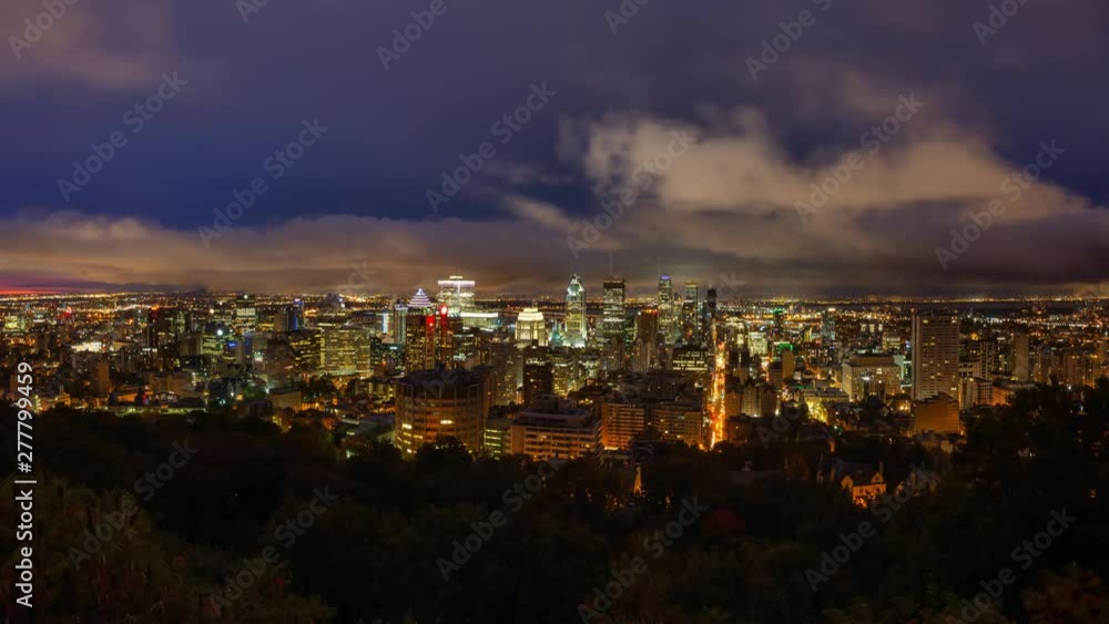 Aerial view of a beautiful modern downtown city during a striking cloudy sunrise. Taken in Mt Royal, Montreal, Quebec, Canada. Still Image Continuous Animation Aerial view of a beautiful modern downtown city during a striking cloudy sunrise. Taken in Mt Royal, Montreal, Quebec, Canada. Still Image Continuous Animation