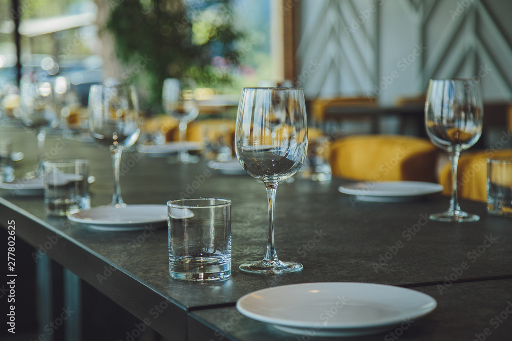 Glass goblets on the table. Served table. Table setting Glass goblets on the table. Served table. Table setting