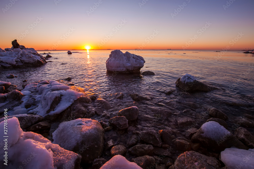 Sunrise by the sea in winter