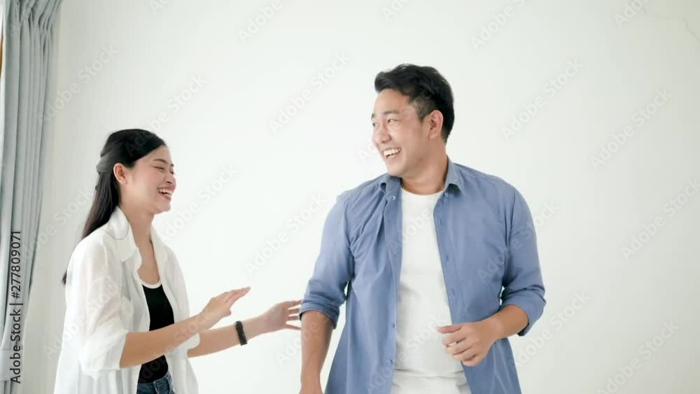 Happy Asian couple dancing together at home, slow motion. Happy Asian couple dancing together at home, slow motion.