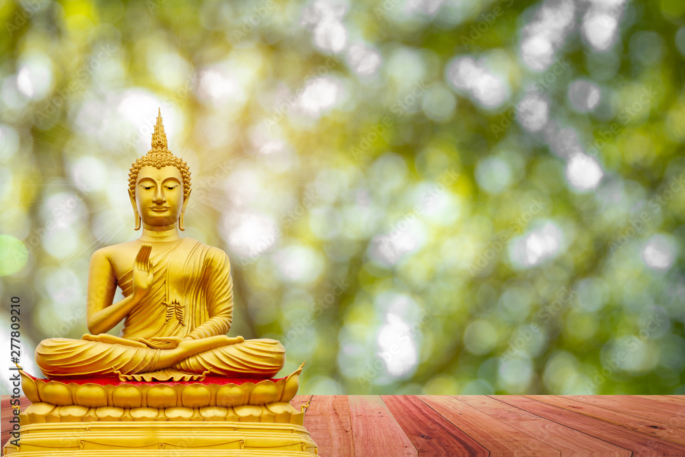 Golden Buddha image under the Bodhi leaf, natural background Golden Buddha image under the Bodhi leaf, natural background