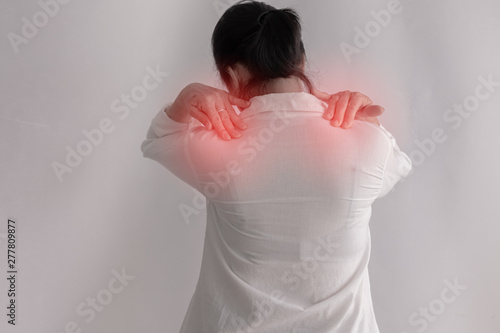 Shoulder pain woman on isolated white background, back view.