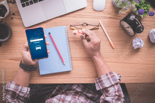 businessman holding smartphone and mock up car, concept of find a car online, used car.