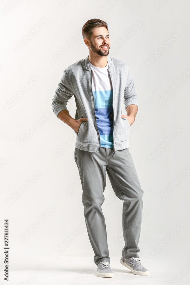 Fototapeta premium Handsome stylish man on light background