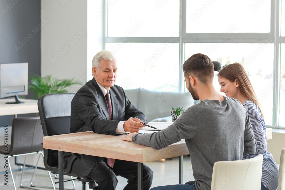 Couple meeting with notary public in office Couple meeting with notary public in office