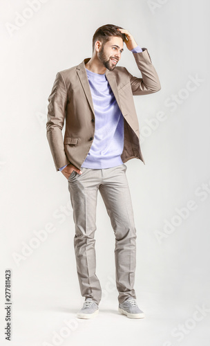 Handsome stylish man on lig...