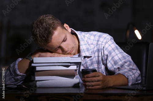 Tired male student sleeping...