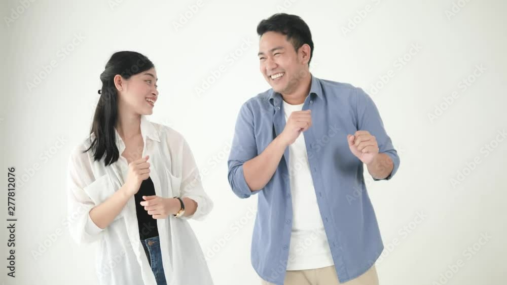 Happy Asian couple dancing together at home, slow motion. Happy Asian couple dancing together at home, slow motion.