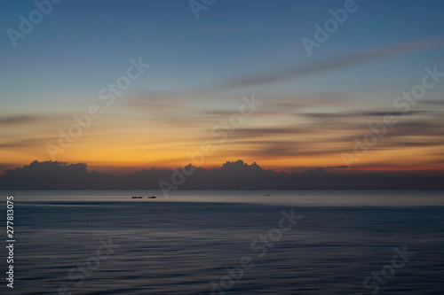 Beautiful seascape with boat in the sea at sunset or sunrise. Natural light background. © Thanaphong