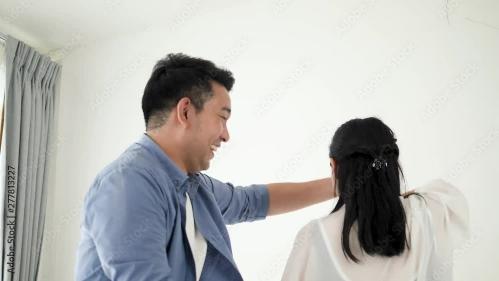 Happy Asian couple dancing together at home, slow motion. Happy Asian couple dancing together at home, slow motion.
