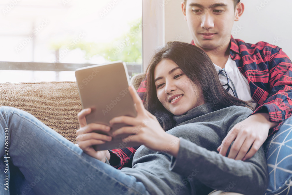Happily young couple use large smartphone at home Happily young couple use large smartphone at home