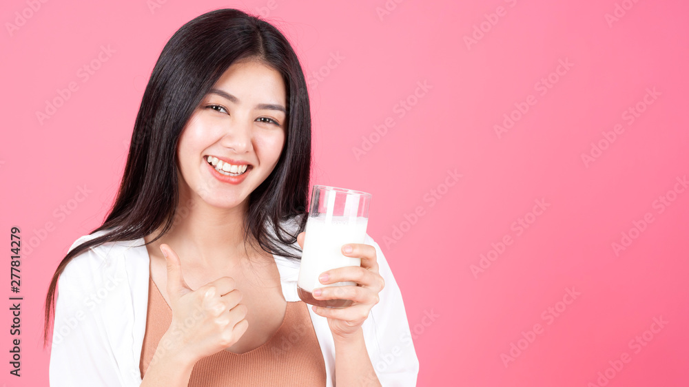 beauty woman Asian cute girl feel happy drinking milk for good health in the morning on pink background - lifestyle beauty woman c beauty woman Asian cute girl feel happy drinking milk for good health in the morning on pink background - lifestyle beauty woman c