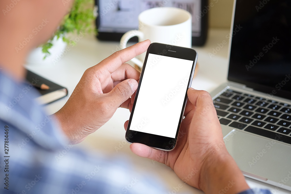 Cropped shot view of man hands holding smart phone with blank copy space screen for your text message or information content, female reading text message on cell telephone during in urban setting. 