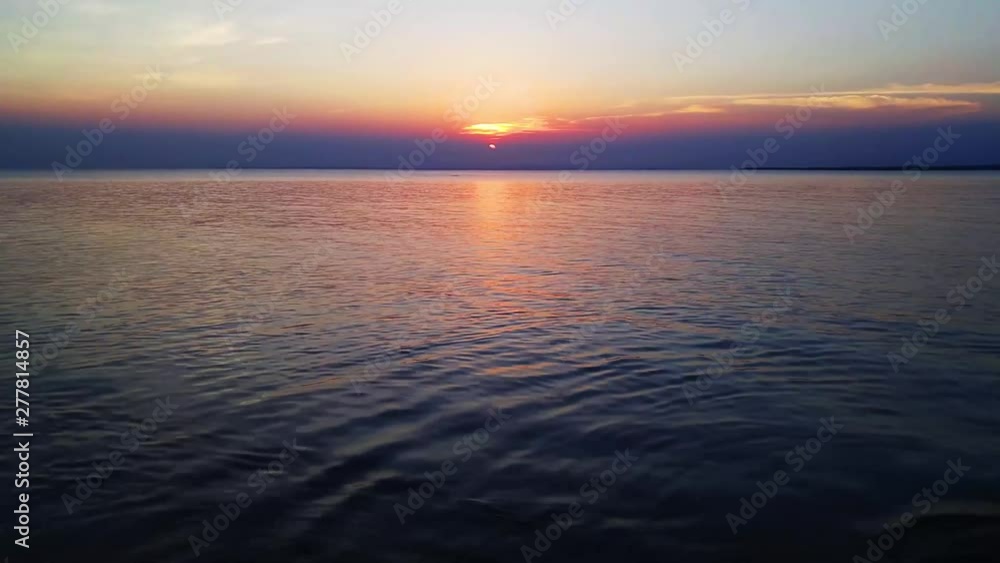 Afternoon shot of sunset on beach with little waves. Afternoon shot of sunset on beach with little waves.