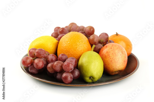 A heap of different tropical fruits isolated on Ceramic plate. Healthy and organic fair concept. - Image
