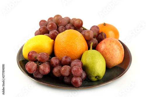 A heap of different tropical fruits isolated on Ceramic plate. Healthy and organic fair concept. - Image