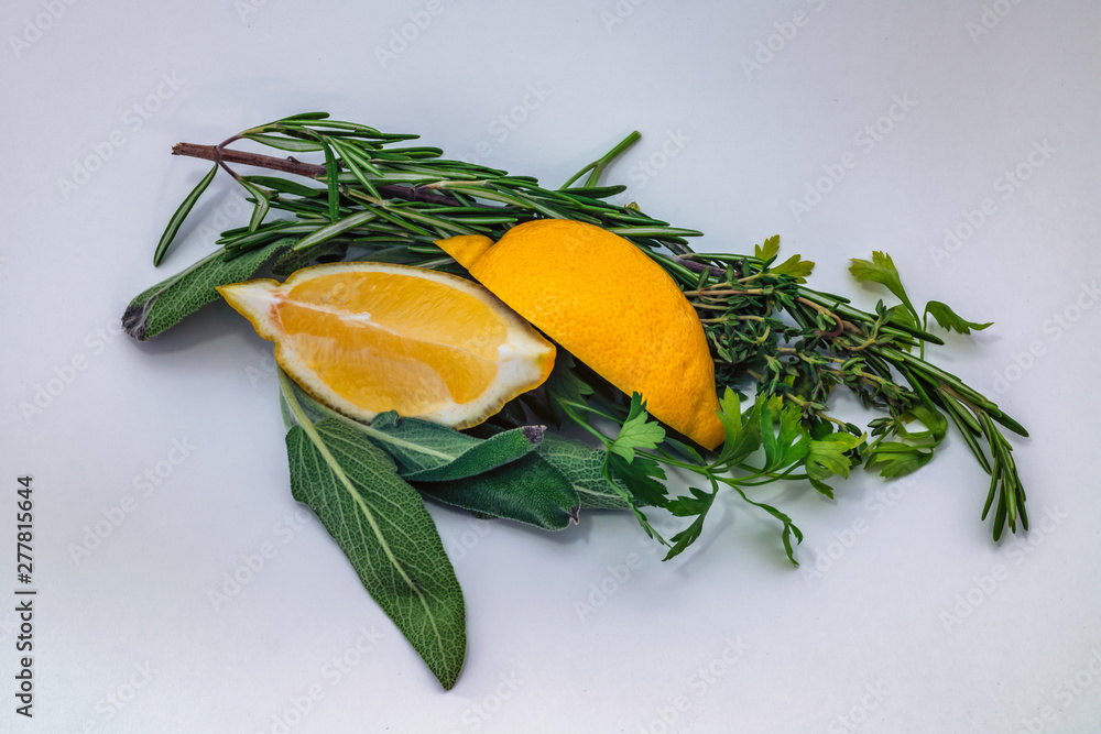 Fresh herbs and lemon isolated on white