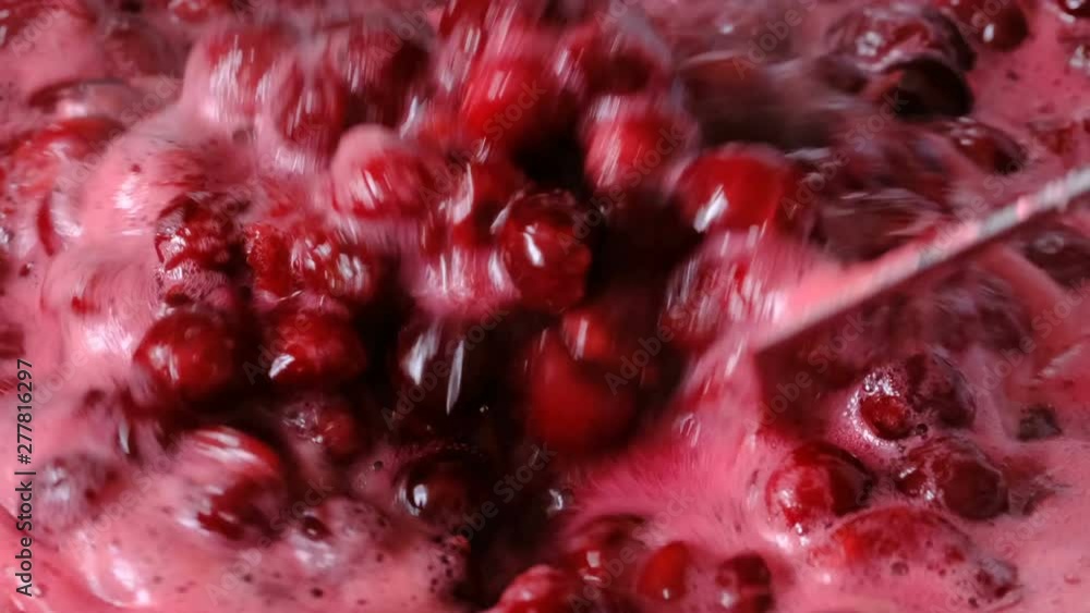 Video clip the process of making cherry jam berries boil in its own juice with sugar filmed close-up Video clip the process of making cherry jam berries boil in its own juice with sugar filmed close-up