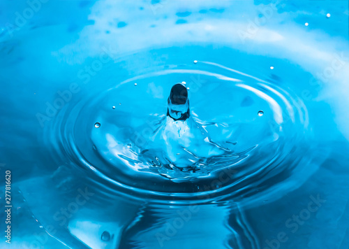 Drop of water. Blue water drop. Water splash close-up. Falling water. Rain close up.