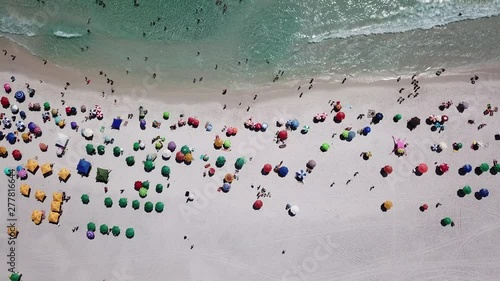 Aerial view of people having fun in a tropical beach and the blue ocean in Arraial do Cabo Rio de Janeiro Brasil.