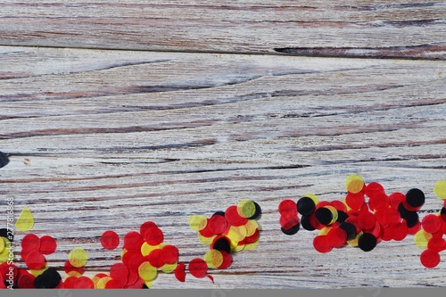 national day of Belgium , July 21. national Belgian festival. the concept of celebration, fun, patriotism and freedom. paper colored confetti on white wooden background.