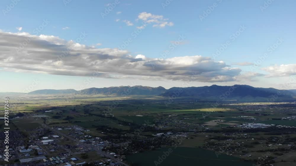 Drone shot over a small town and the mountains in the distance. (Bozeman, Montana) Drone shot over a small town and the mountains in the distance. (Bozeman, Montana)