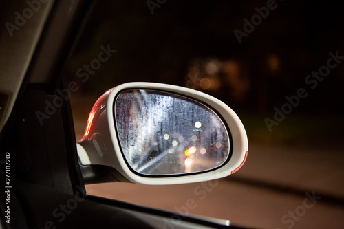 car mirror at rainy night 
