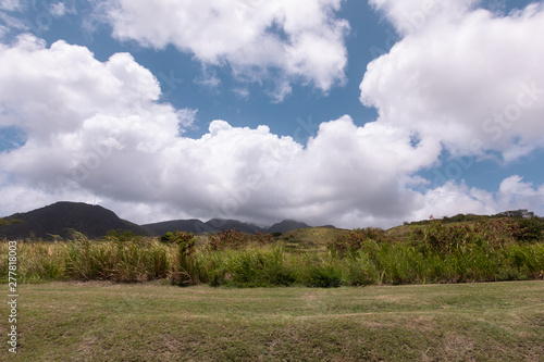 clouds over mountains and field