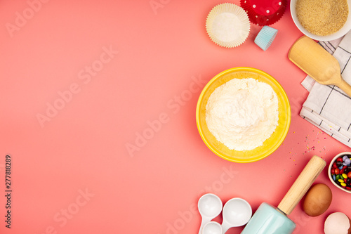 Baking or cooking ingredients on pink background, flat lay