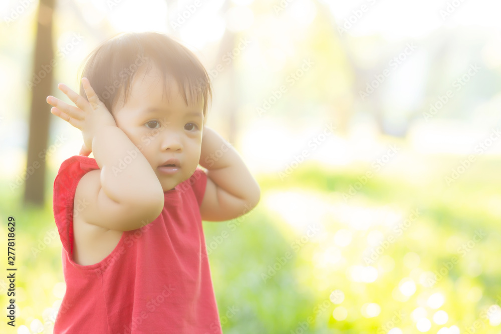 Portrait face of cute asian little girl and child happiness and fun in the park in the summer, smile and happy from asia kid and relax in the garden, lifestyle childhood concept. Portrait face of cute asian little girl and child happiness and fun in the park in the summer, smile and happy from asia kid and relax in the garden, lifestyle childhood concept.