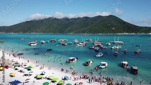 Drone view tropical beach with boats in the blue ocean in Arraial do cabo, Rio de Janeiro Brasil.
