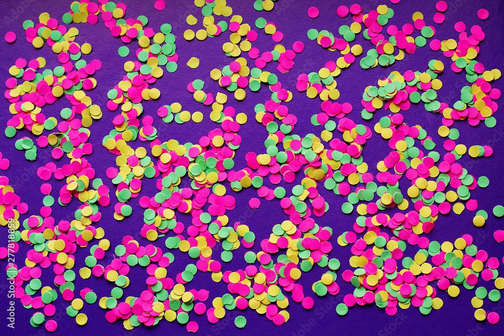 Multicolored confetti in on a dark background