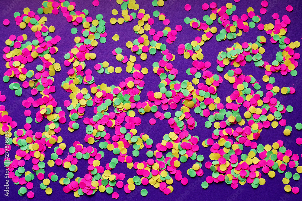 Multicolored confetti in on a dark background Multicolored confetti in on a dark background
