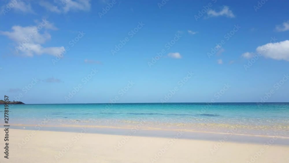 Crystal clear waters of a beach crashing along the shoreline Crystal clear waters of a beach crashing along the shoreline