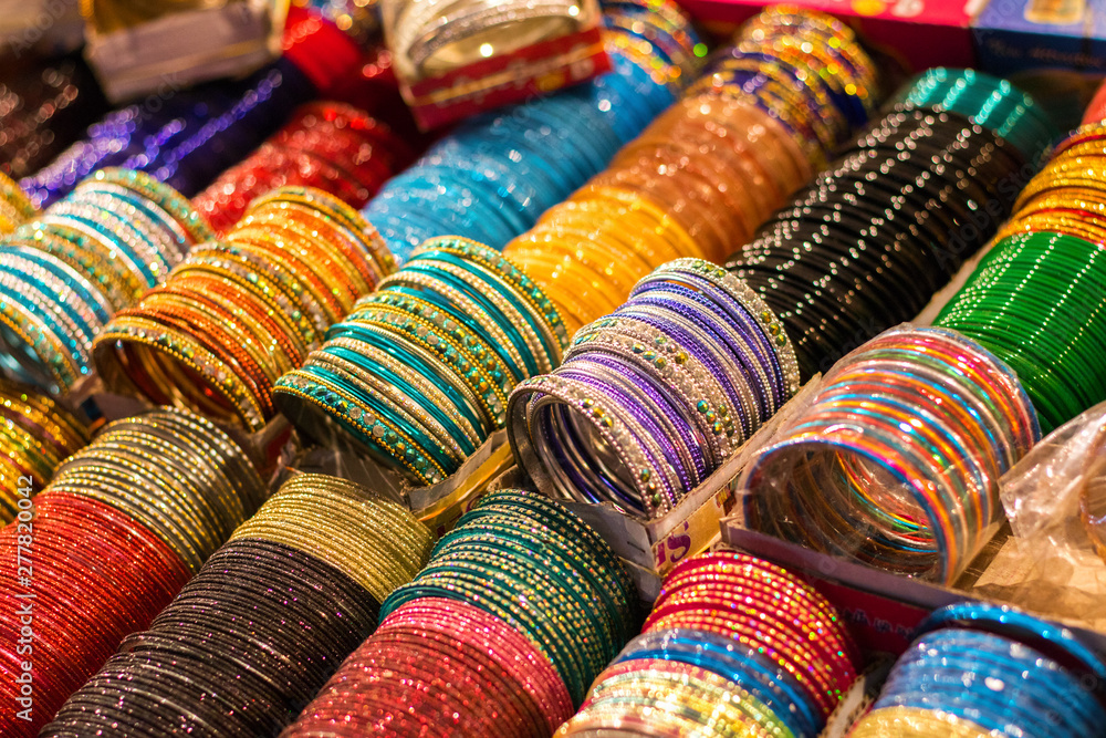 Multi-Colored Indian Glass/Metal Bangles Arranged On The Shelf For Sale Multi-Colored Indian Glass/Metal Bangles Arranged On The Shelf For Sale